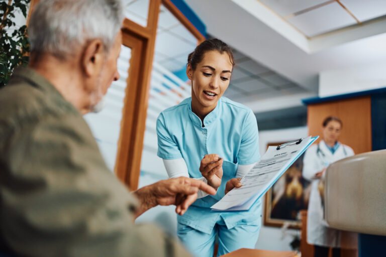 young-nurse-assisting-senior-man-in-filling